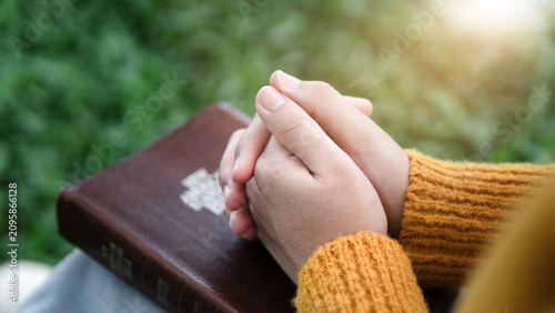 Foto Christian Prayer with Folded Hands on Holy Bible in Nature, Faith and Spiritual