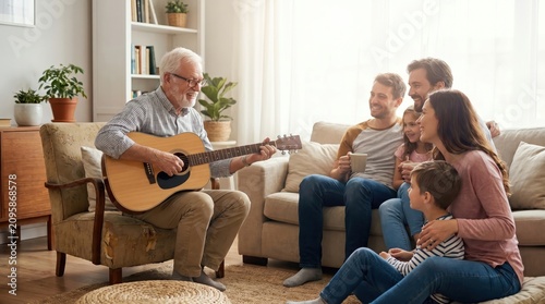 Grandfather Playing Guitar for Family on Senior Citizen Day