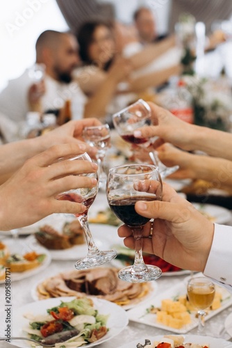 Konstfotografi Guests making a toast with wine at celebration