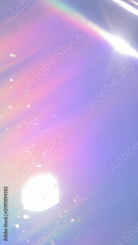 Diagonal light rays on soft lavender background.