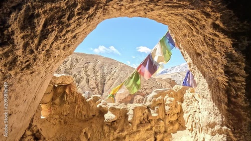 Wide valley village red gold monastery eroded cliffs Chhoser Upper Mustang Nepal