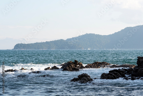 Rocky headlands and rocks are struck by powerful waves that crash with energy. Angra dos Reis – Rio de Janeiro, Brazil.