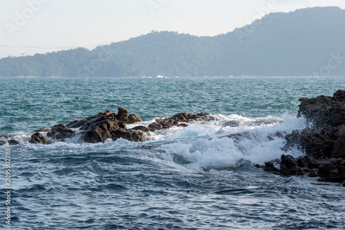 Rocky headlands and rocks are struck by powerful waves that crash with energy. Angra dos Reis – Rio de Janeiro, Brazil.