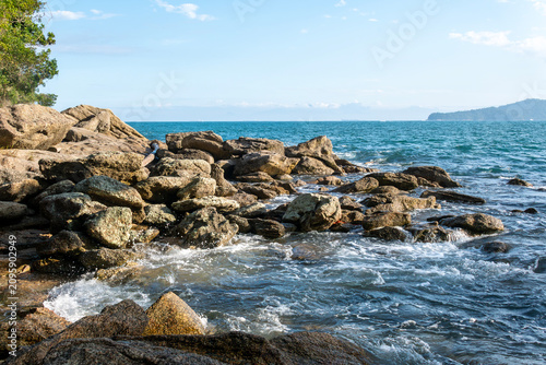 Rocky headlands and rocks are struck by powerful waves that crash with energy. Angra dos Reis – Rio de Janeiro, Brazil.