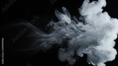 A mesmerizing display of white ink gracefully swirling and dispersing in a dark, fluid environment, creating an abstract and captivating visual effect.