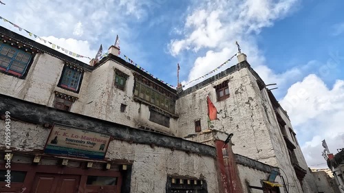 Low angle souvenir shop facade prayer flags and Royal Palace exterior, Lo Manthang Upper Mustang Nepal