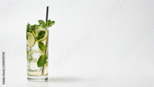 Bild auf Leinwand A tall glass of refreshing mojito cocktail garnished with fresh green mint leave