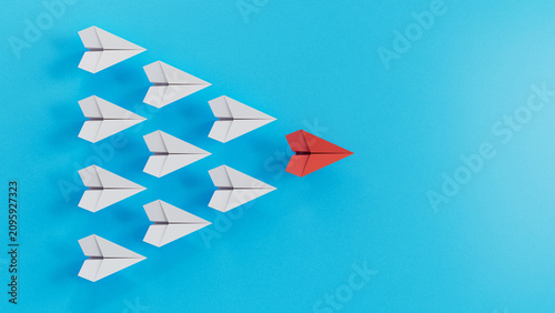 Multiple White Paper Planes Converge Toward One Red Leader Plane