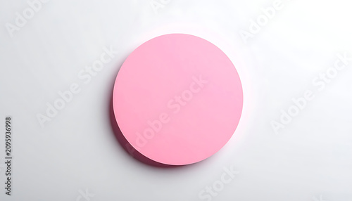 Pastel Pink Circular Disk Resting On Soft Gray Gradient Surface With Shadow