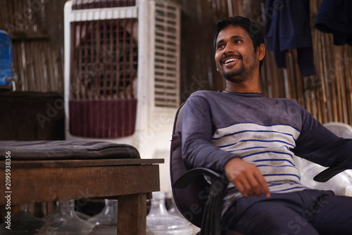 Rickshaw puller resting  in his hut