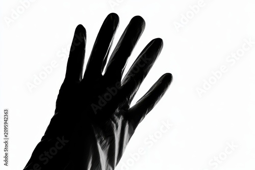 Black hand silhouette reaching against a stark white background in a high contrast noir style for mystery thriller marketing