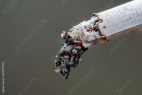 Fotografie Macro close-up of a burning cigarette with glowing ash