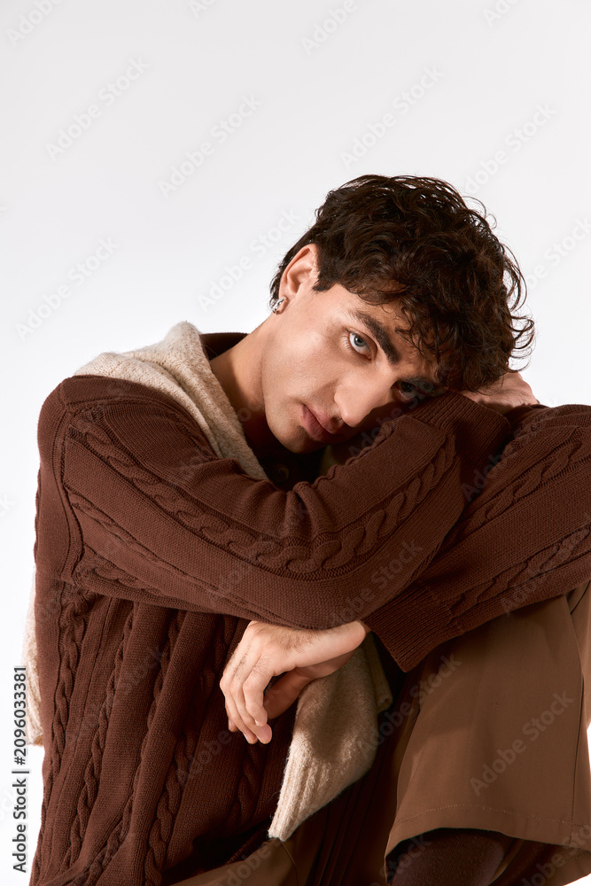 Fototapeta premium Handsome young man showcasing modern fashion and elegance with charismatic charm in stylish attire