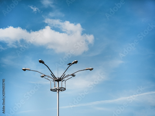 Modern street light pole against blue sky with copy space