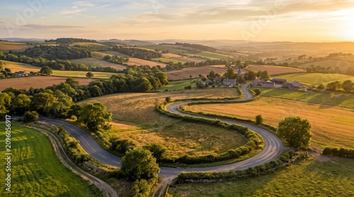 Winding asphalt road through rolling green hills at sunset a scenic countryside landscape rural highway