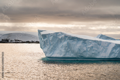 Massive Iceberg Floating in the Antarctic Ocean. Zodiac Landing During an Antarctic Expedition Cruise