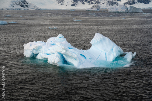 Massive Iceberg Floating in the Antarctic Ocean. Zodiac Landing During an Antarctic Expedition Cruise
