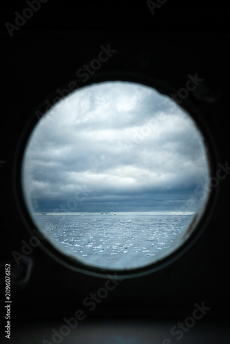 Antarctic Landscape Viewed Through a Ship Cabin Porthole