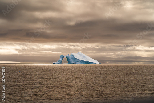 Massive Iceberg Floating in the Antarctic Ocean. Zodiac Landing During an Antarctic Expedition Cruise