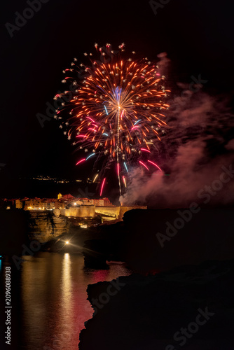 Fireworks illuminating Bonifacio cliff town cityscape at night