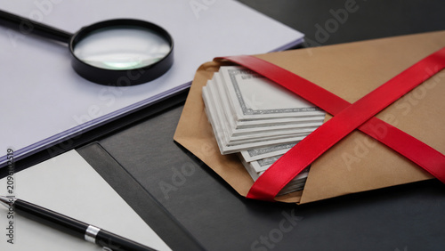Envelope with generic money crossed by red warning ribbon