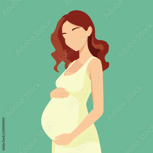 Pregnant woman with auburn hair wears a light yellow dress while standing against a soft green background.