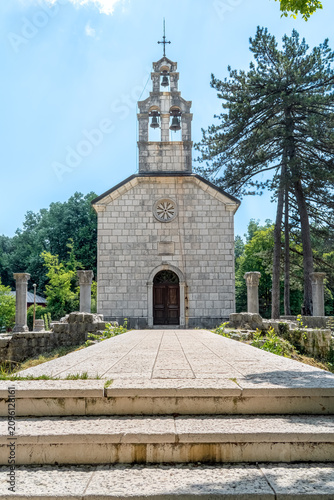Front view of the Court Church on Cipur in Cetinje, Montenegro. Symmetric Orthodox architecture with a bell tower and stone path leading to the entrance of the royal chapel in Europe