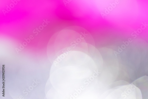 Soft pink and white bokeh light background. Abstract blurry circles with gentle texture for romantic backdrop