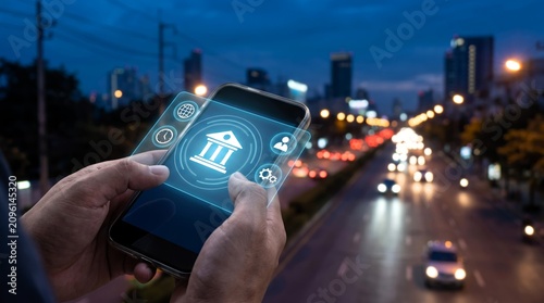 Hands holding a modern smartphone displaying a glowing blue bank icon with various digital interface symbols for financial services