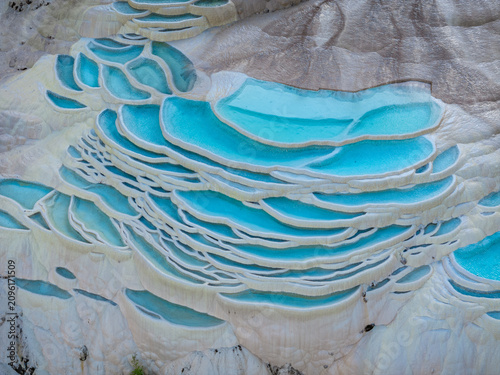 Fotografie Pamukkale in Turkey featuring white travertine terraces filled with turquoise th