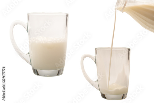 Obraz na plátně Milk is being poured from a bottle into a cup.