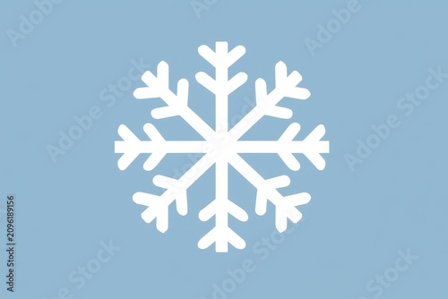 Snowflake crystal resting on a light blue background in a sharp focus macro studio shot for winter holiday branding