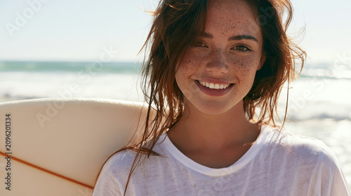 young stylish woman smiling on the beach