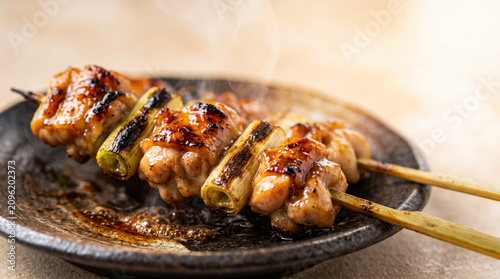 皿に盛られた香ばしい焼き鳥　タレの掛かったねぎまなどのやきとり