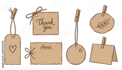 Vintage style kraft paper tags and memo notes with rope bows and pressed branch illustrations secured with wooden clips perfect for gift wrapping and personal crafts.