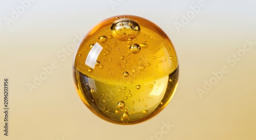 Close-up of a golden, transparent liquid sphere.