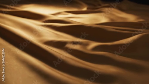 Silk fabric laying flat with natural light shining on it in a close-up view