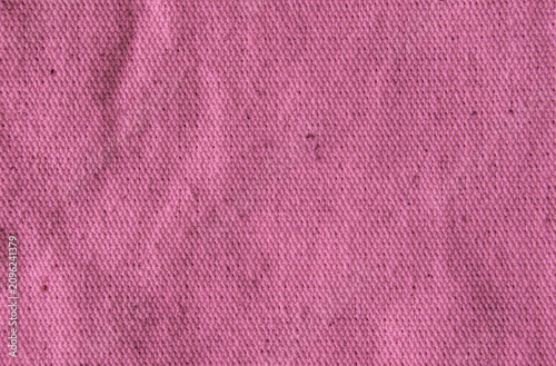 Close up bright wallace candy pink cotton linen canvas texture with woven details. Natural coarse texture for design fabric background. Rough crumpled hessian burlap background.