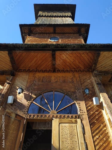 Traditional Wooden Architecture in Zakopane with Intricate Carvings and Blue Sky