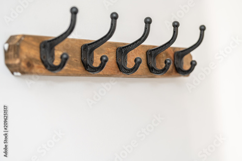 Konstfotografi Rustic wooden wall coat rack with five black metal hooks