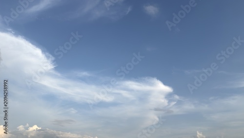 Obraz na płótnie A clear blue sky featuring large white cloud formations during daylight