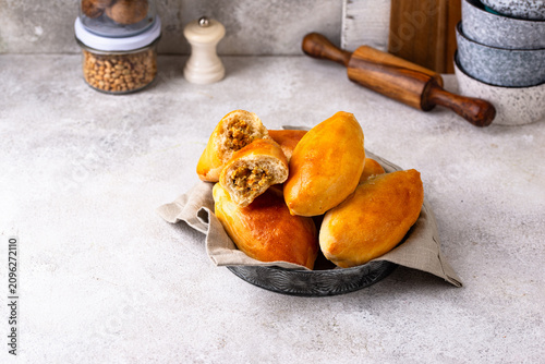 Cuadro en lienzo Traditional baked pies pirozhki with meat.