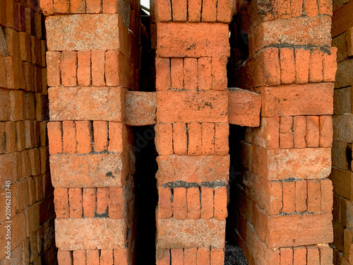 Fotografía Stacks of Fired Red Clay Bricks Inside a Traditional Brick Kiln