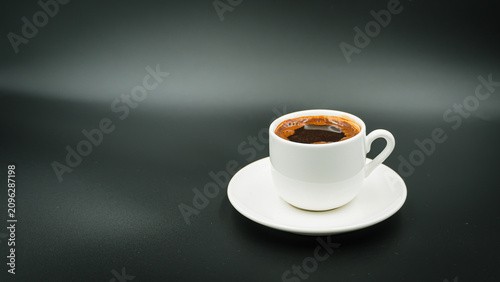 White Cup of Hot Turkish Coffee Isolated on a Black Background