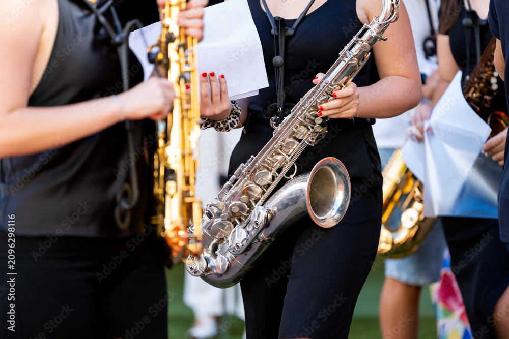 Obraz premium Young spanish musicians performing saxophone street concert