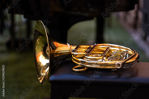 French horn resting on a bench, ready for a street concert performance