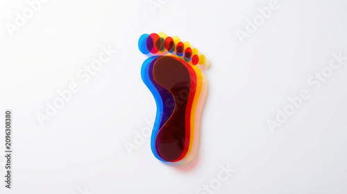 Abstract footprint overlapping colorful foot shape with red, blue, and yellow layers on white background