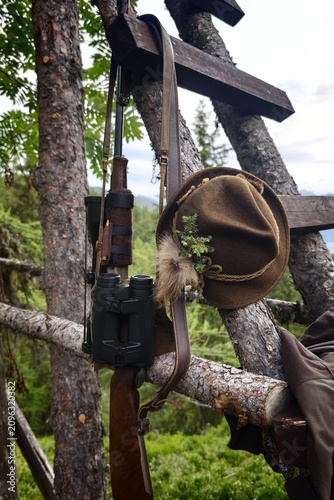still life of hunting equipment on a high seat in the mountains
