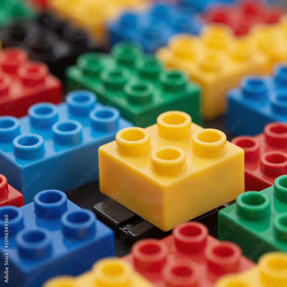Fototapeta premium Cinematic Plastic Finance. Construct A Digital Illustration Of An Intricate, Colorful Structure Made With Interlocking Plastic Building Blocks