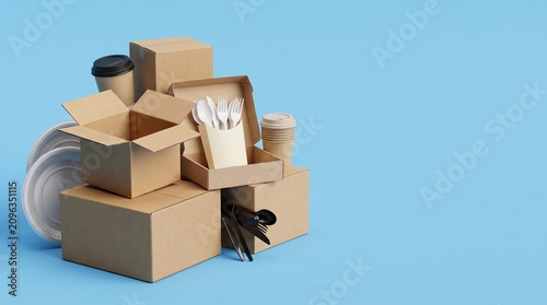 Cardboard takeout food delivery boxes with disposable cutlery and cups on blue background